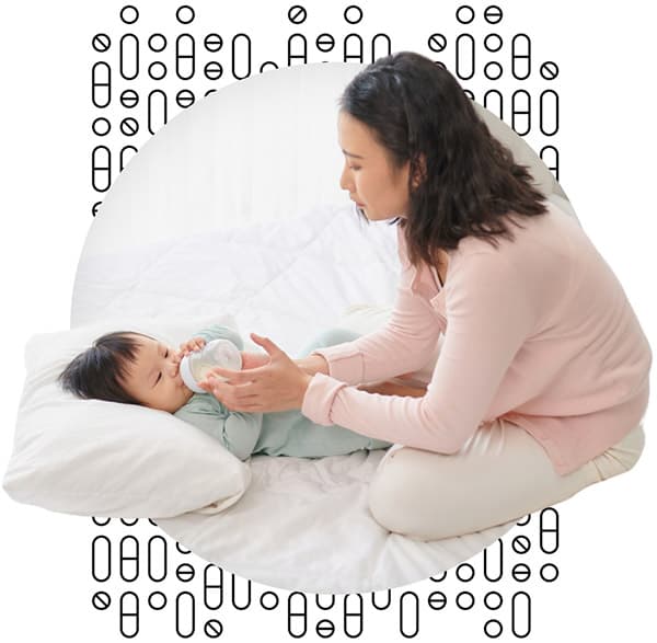 Mother feeding infant with a bottle of milk