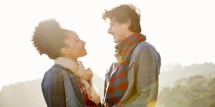 Couple smiling at each other at the beach