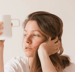 A woman with a pensive, weary expression, suggestive of someone struggling with illness