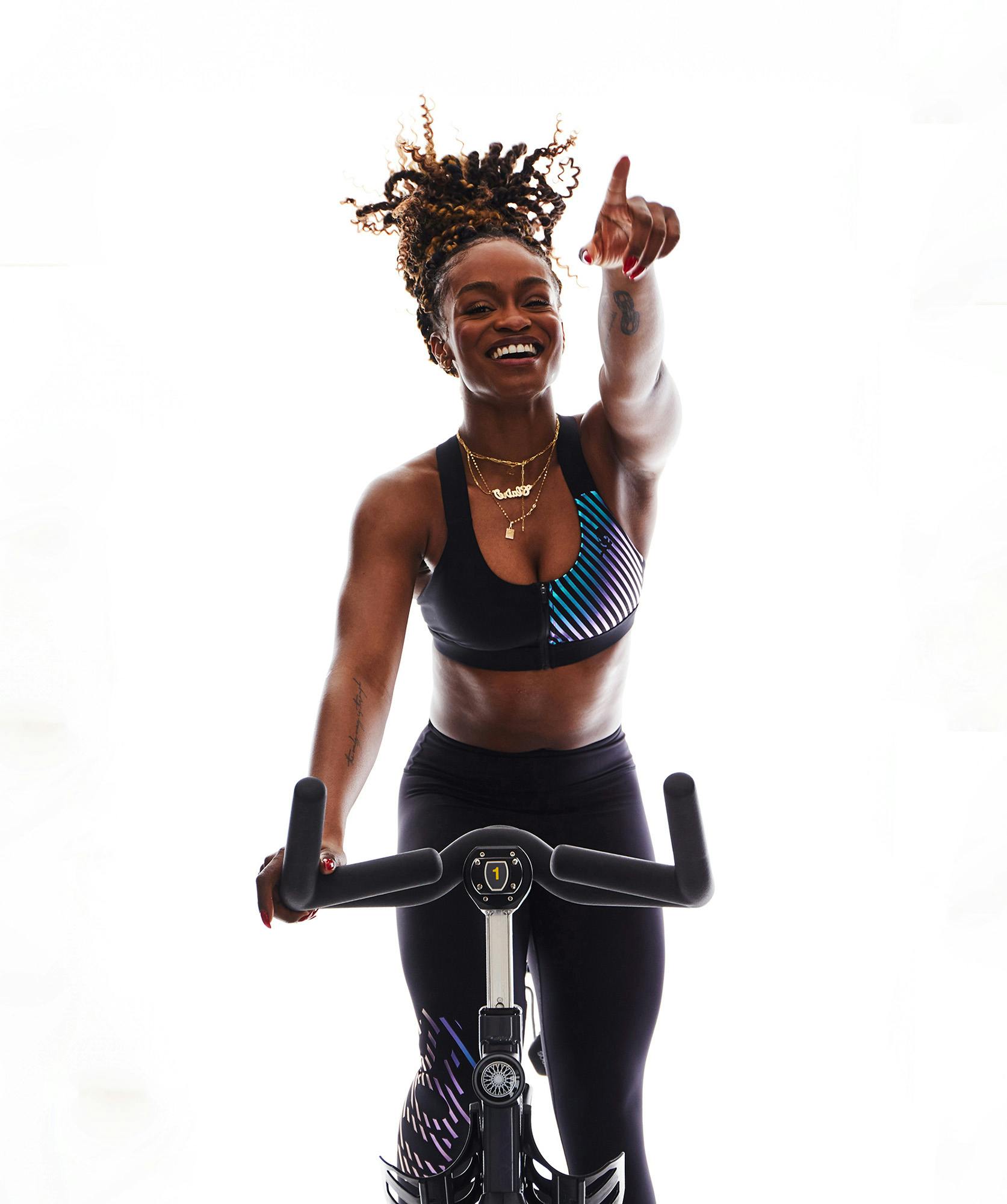 A woman in workout clothes riding a SoulCycle bike